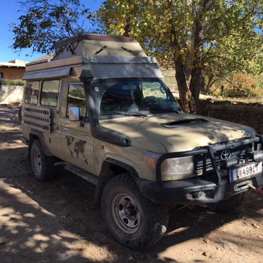 4-wheel-drive Toyota with heated water for a shower, a stove and an iridium-based alarm system.