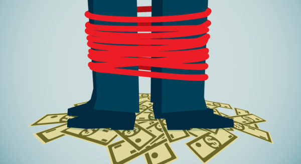 Central banker's shoes tied on top of a pile of notes