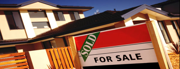 A For sale sign and a sold stamp on it